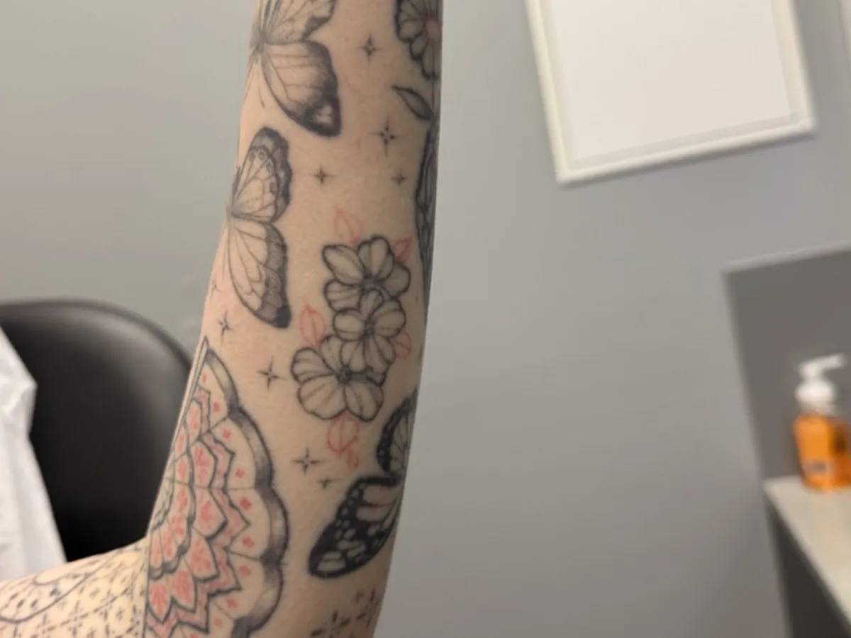 Colour Japanese floral sleeve tattoo on the forearm before laser removal